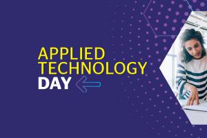 Students Look over a document, text reads "Applied Technology Day"