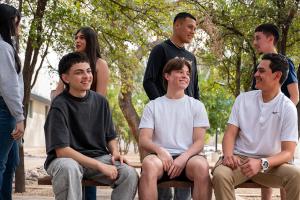 6 students converse in a campus courtyard