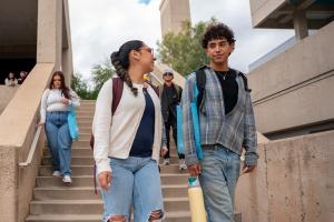 Two Students walk in a west campus courtyard